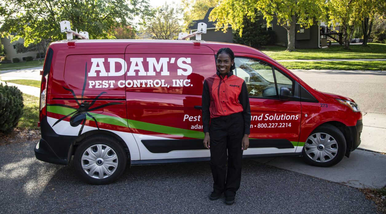 pest control technician standing by adams van