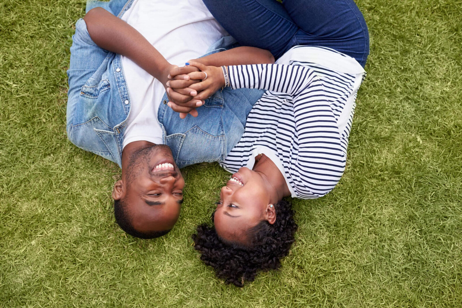 african american couple laying on grass