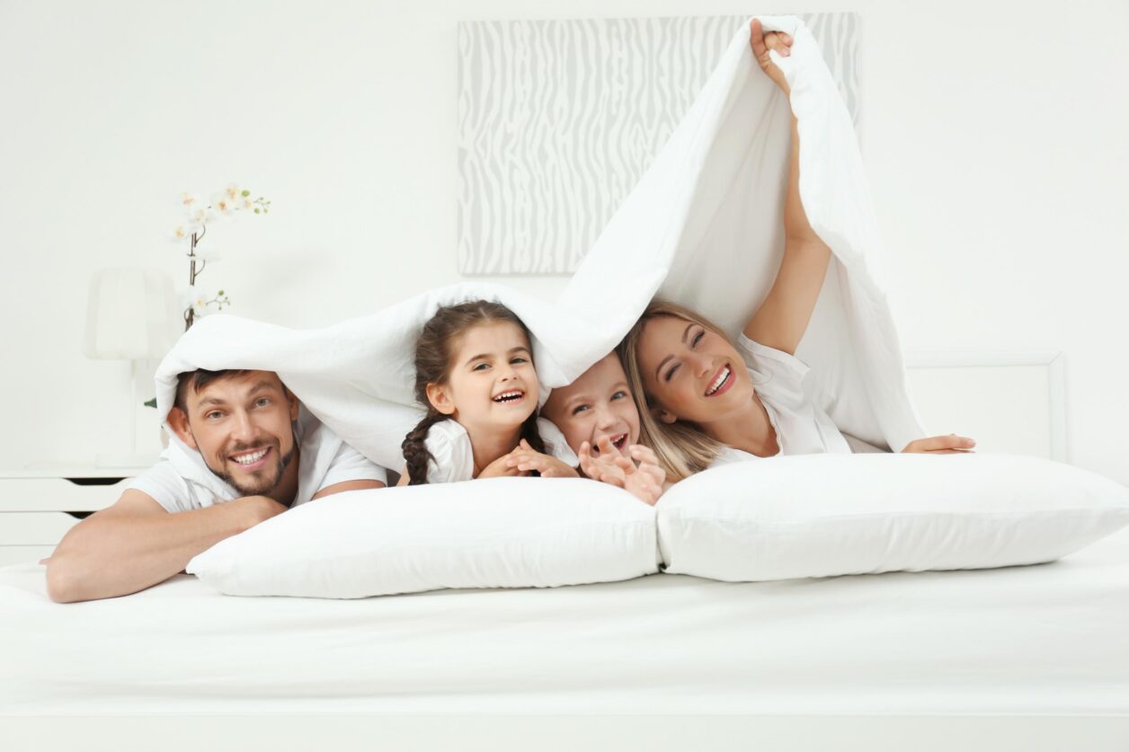 family having fun in bed