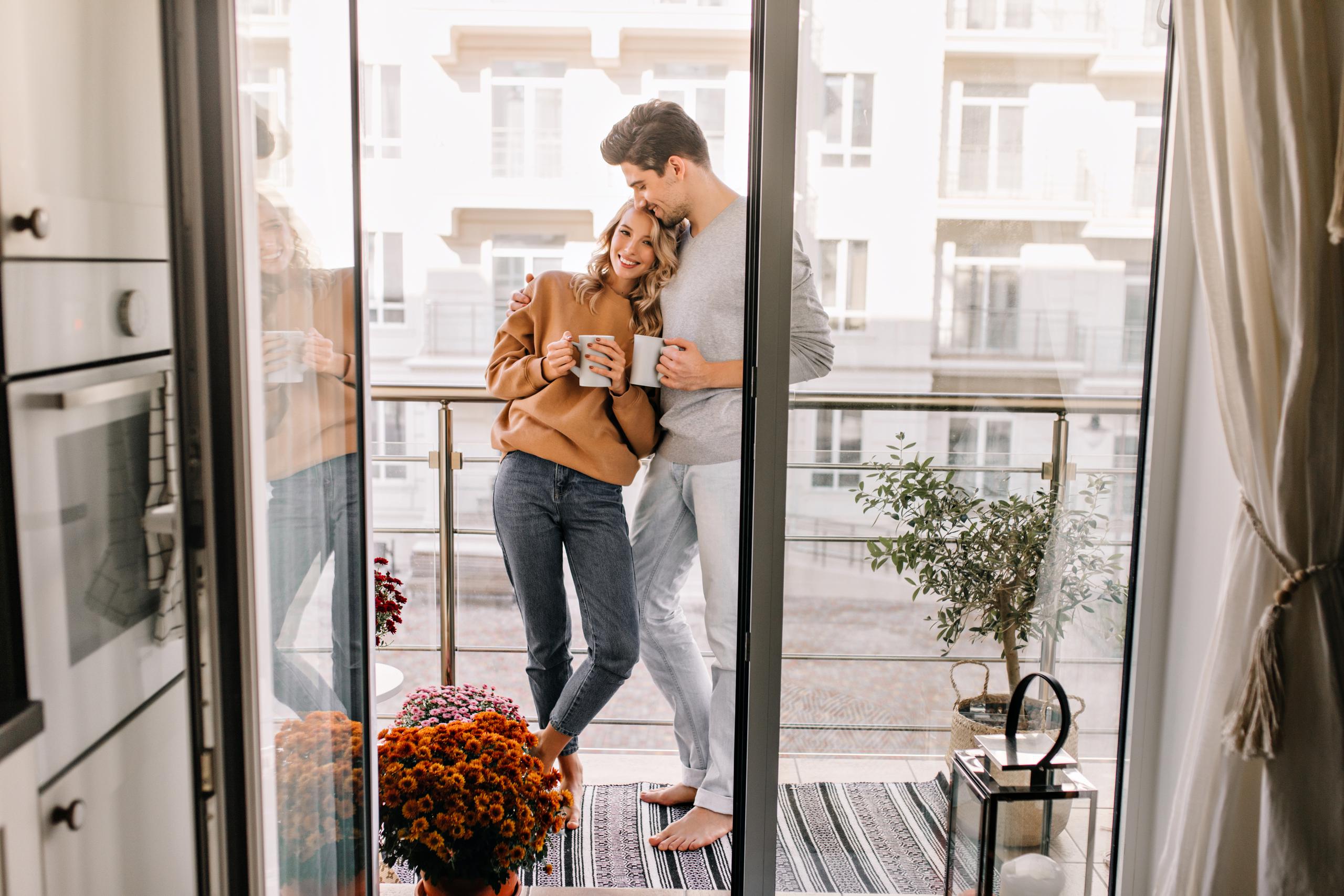 couple cuddling on deck with drinks