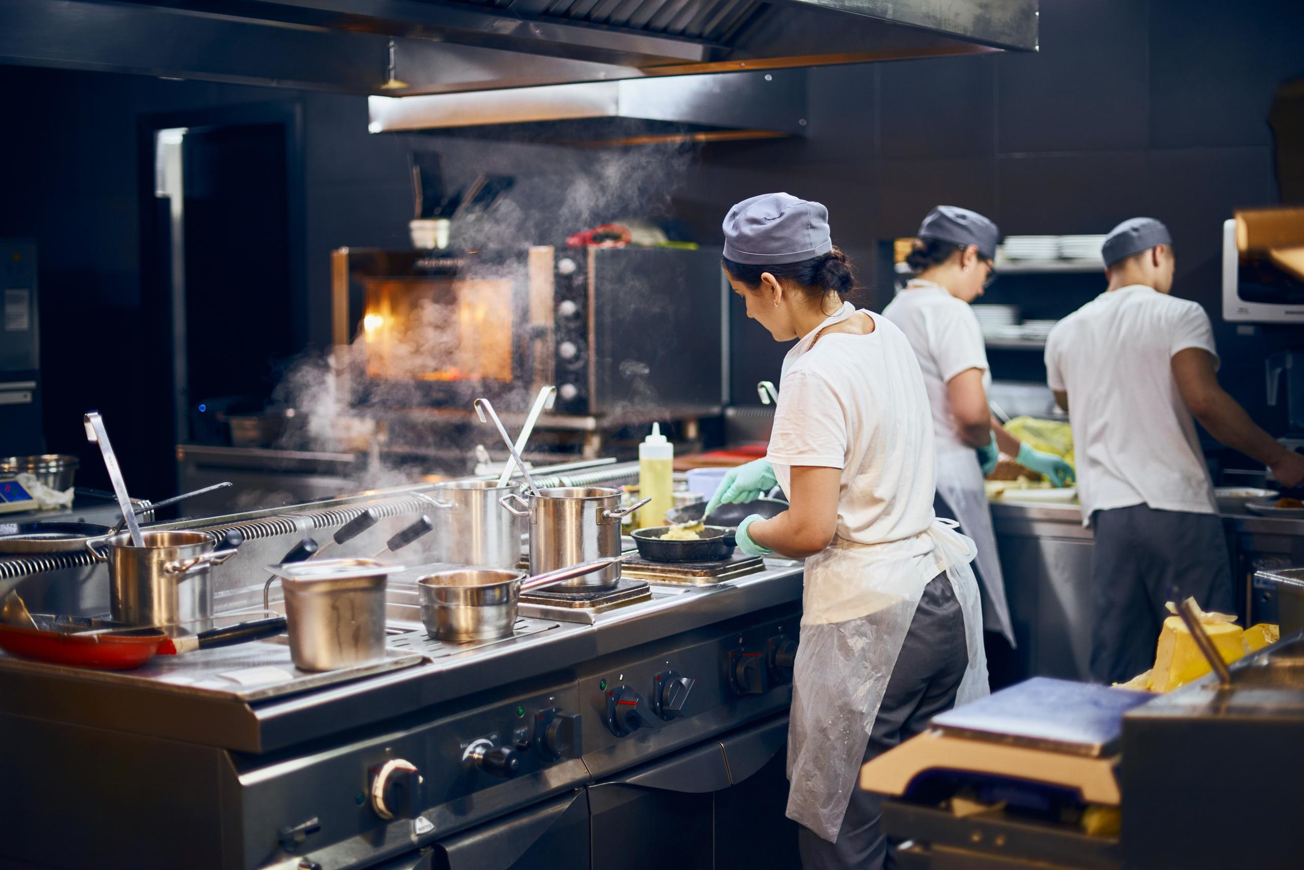 woman cooking in commercial kitchen