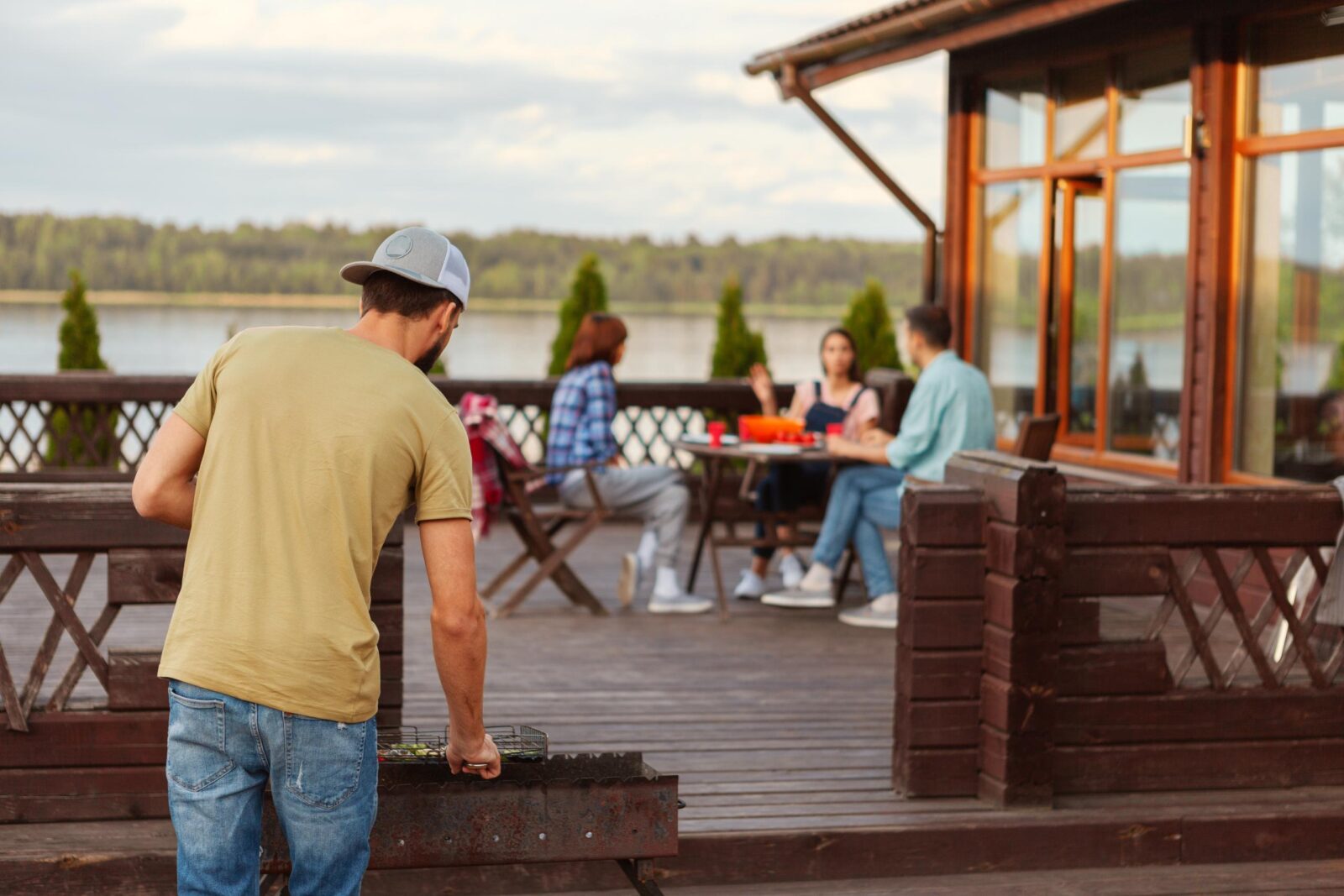 Image of man grilling on the deck